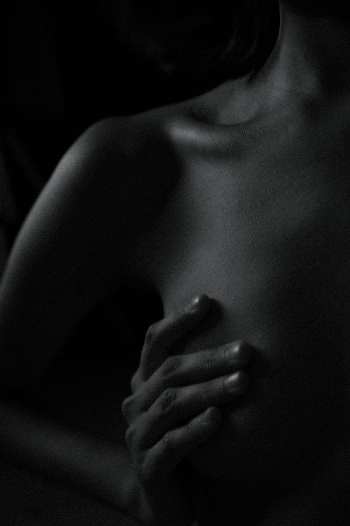 About 1 - Porn Dude An artistic black and white photo emphasizing the form and contours of the human body in low light.