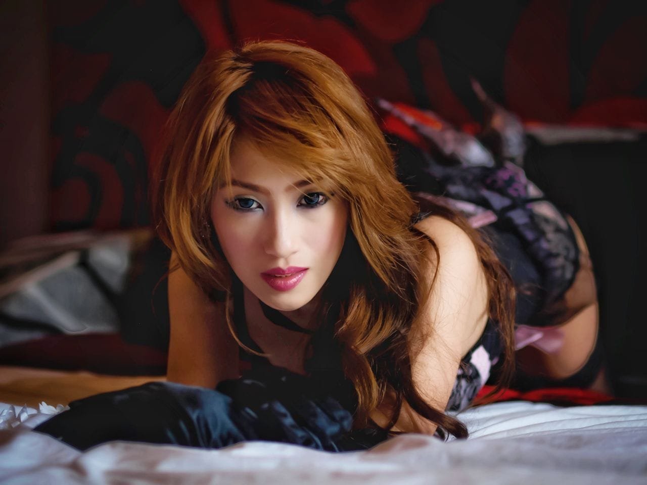 Home 6 - Porn Dude Seductive redhead woman with wavy hair posing elegantly while lying down indoors.